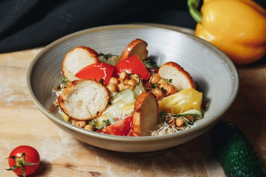 A colorful chickpea salad featuring plump chickpeas and assorted fresh vegetables, creating a delightful and nutritious dish.