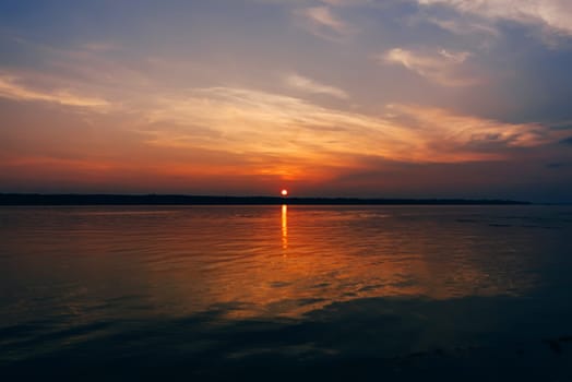 sunset over the river and a beautiful sky on a summer evening