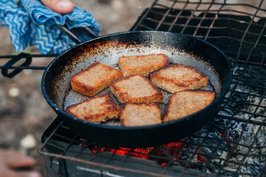 toast bread roasting on the fire camping in the nature