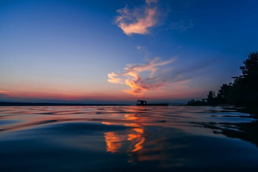red blue sunset with beautiful reflection in the water waves of the sea