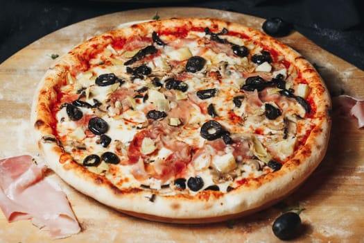 A gourmet pizza with a variety of olives beautifully arranged on a rustic wooden board.