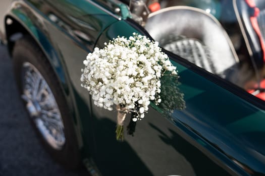 Convertible with a bouquet of gypsophila as decoration for a wedding