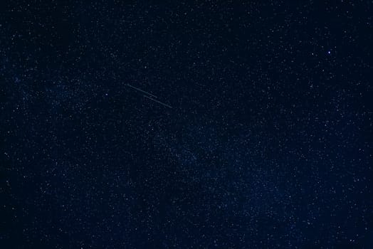 shooting stars in the starry dark blue night sky