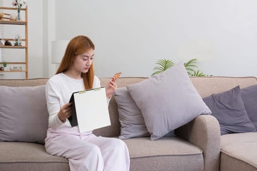 A young woman with a calendar and birth control pills reads instructions on how to use them correctly..