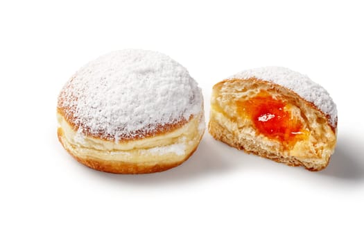 Appetizing fluffy fruit-flavored doughnuts filled with sweet and sourish apricot jelly, sprinkled with powdered sugar isolated on white background