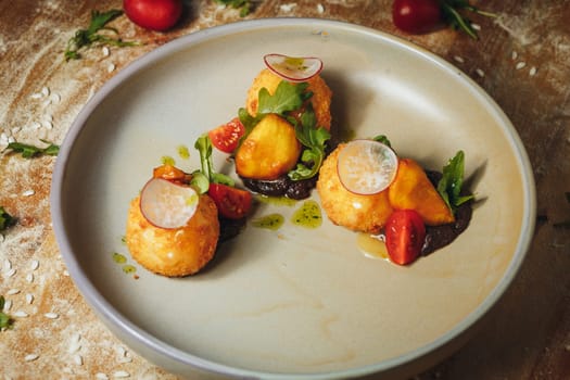 A plate of food featuring a ripe tomato and fresh radishes, showcasing a vibrant and appetizing array of colors and textures.