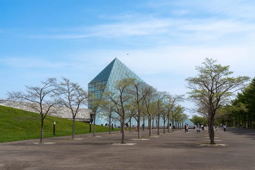 SAPPORO, JAPAN - 05 MAY 2024 : The symbol of Moerenuma park, the glass pyramid Hidamari, on February 5 in Sapporo. The glass pyramid is multi-purpose space, such as cultural activities and museum.