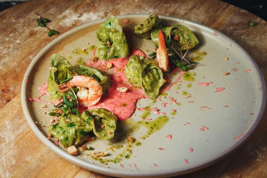 A plate adorned with juicy shrimp drenched in a vibrant green sauce, creating an enticing and flavorful culinary masterpiece.