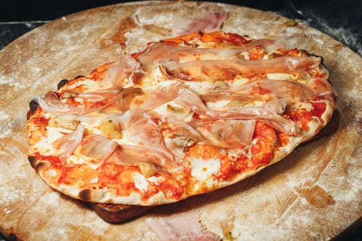 A delicious pizza topped with savory ingredients rests elegantly on a wooden board.