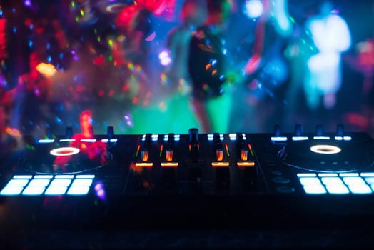 music mixer DJ controller Board for professional mixing of electronic music in a nightclub at a party
