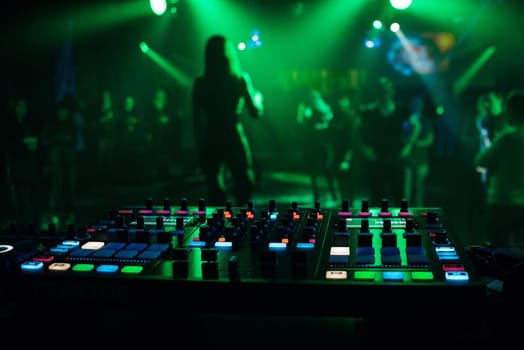 music mixer DJ controller Board for professional mixing of electronic music in a nightclub at a party