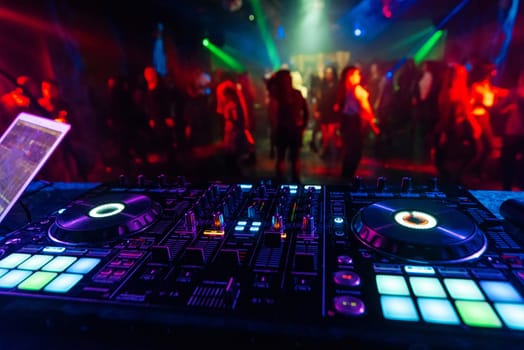 music mixer DJ controller Board for professional mixing of electronic music in a nightclub at a party