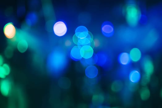 blurred abstract background with colorful bokeh from bright spotlights in a nightclub