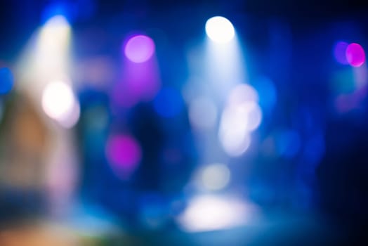 multicolored bokeh from bright colored spotlights in a nightclub in out of focus