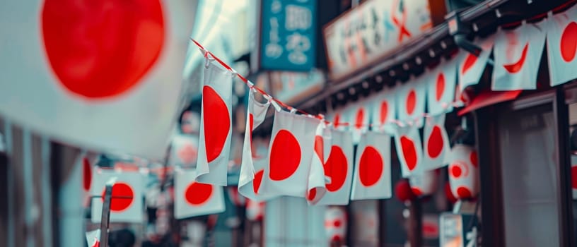 Red and white Japanese flags strung across a street, creating a festive atmosphere in a bustling urban area