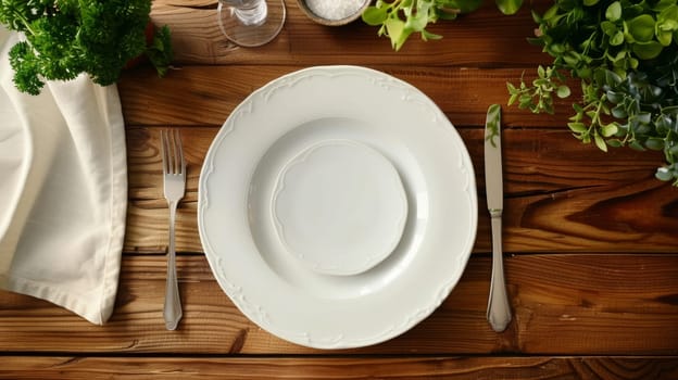 Top view of a simple yet elegant table setting with clean white plates and silver cutlery on a rich wooden background