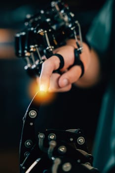 Teenage boy explores technology testing a robot hand and arm in a technical college. Embracing AI humanity and innovative learning experiences.