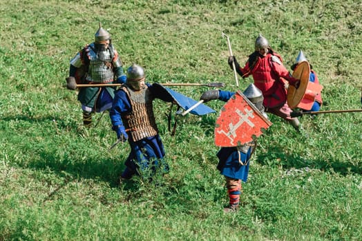 LUH, RUSSIA - AUGUST 27, 2016: Reconstruction of medieval battle of knights in armor and weapons at the festival of Onions in the village of Luh