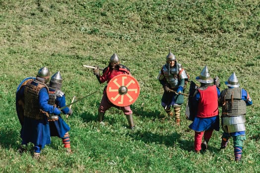 LUH, RUSSIA - AUGUST 27, 2016: Reconstruction of medieval battle of knights in armor and weapons at the festival of Onions in the village of Luh