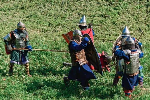 LUH, RUSSIA - AUGUST 27, 2016: Reconstruction of medieval battle of knights in armor and weapons at the festival of Onions in the village of Luh