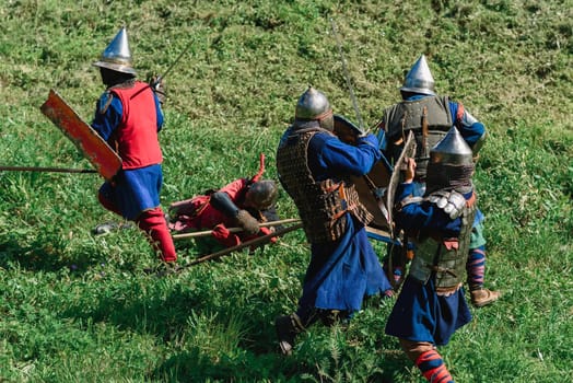 LUH, RUSSIA - AUGUST 27, 2016: Reconstruction of medieval battle of knights in armor and weapons at the festival of Onions in the village of Luh