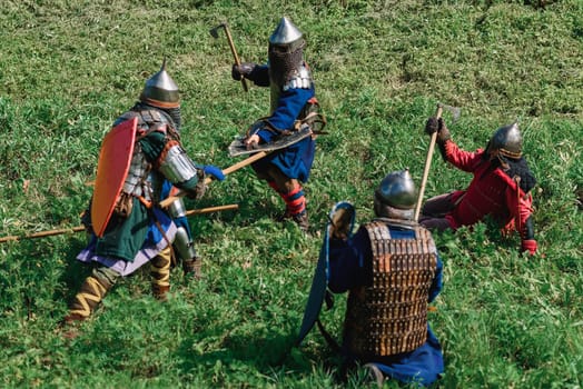 LUH, RUSSIA - AUGUST 27, 2016: Reconstruction of medieval battle of knights in armor and weapons at the festival of Onions in the village of Luh