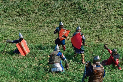 LUH, RUSSIA - AUGUST 27, 2016: Reconstruction of medieval battle of knights in armor and weapons at the festival of Onions in the village of Luh