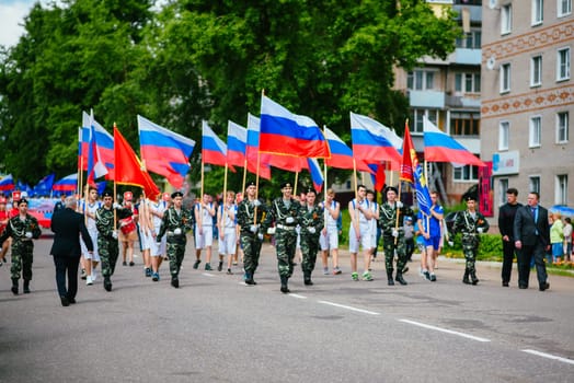 VICHUGA, RUSSIA - JUNE 24, 2017: Festive procession of people on the street on the Day of Vichuga, Russia