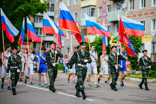 VICHUGA, RUSSIA - JUNE 24, 2017: Festive procession of people on the street on the Day of Vichuga, Russia
