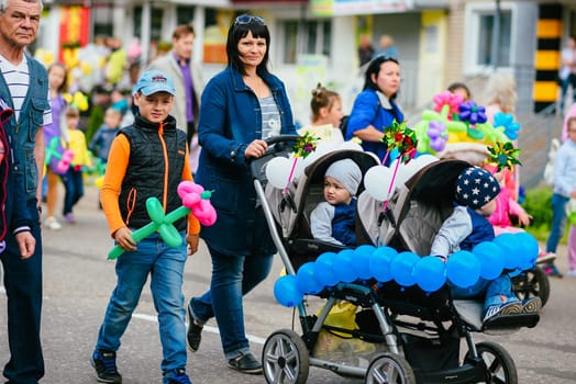 VICHUGA, RUSSIA - JUNE 24, 2017: Festive procession of people on the street on the Day of Vichuga, Russia
