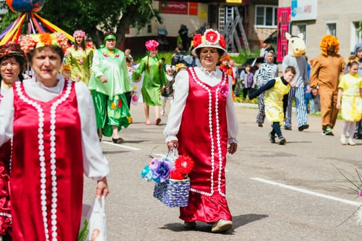VICHUGA, RUSSIA - JUNE 24, 2017: Festive procession of people on the street on the Day of Vichuga, Russia