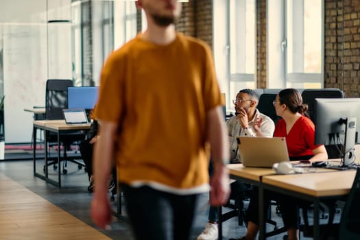 A diverse group of young business individuals congregates in a modern startup coworking center, embodying collaborative innovation and a dynamic atmosphere