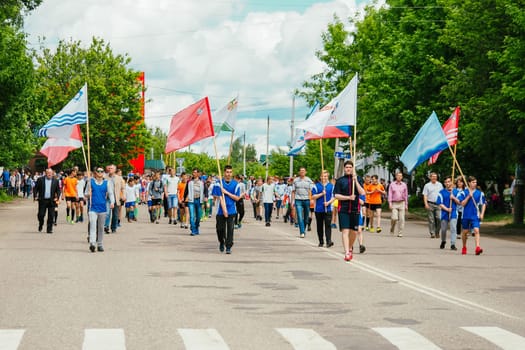 VICHUGA, RUSSIA - JUNE 24, 2017: Festive procession of people on the street on the Day of Vichuga, Russia