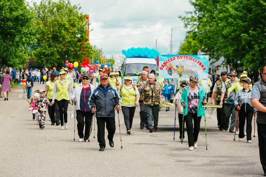 VICHUGA, RUSSIA - JUNE 24, 2017: Festive procession of people on the street on the Day of Vichuga, Russia