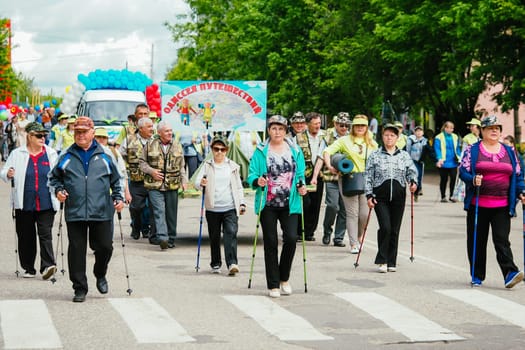 VICHUGA, RUSSIA - JUNE 24, 2017: Festive procession of people on the street on the Day of Vichuga, Russia
