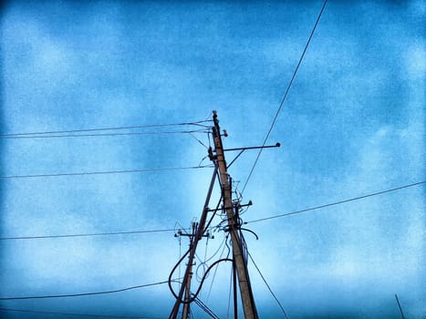 Old pole with wires against the sky. Electric transmission line, Eco-friendly energy