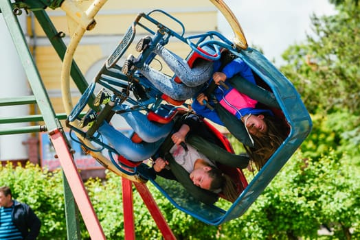 VICHUGA, RUSSIA - JUNE 24, 2017: Two girls ride a carousel in the Park on the Day of Vichuga, Russia