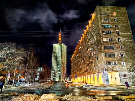 Arkhangelsk, Russia - February 28, 2024: street at night in winter. Snowy, cobblestone street adorned with lights