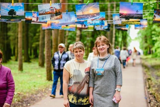 VICHUGA, RUSSIA - JUNE 24, 2017: Two women at a photo exhibition in the Park on the day of Vichuga, Russia