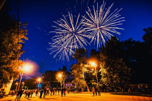 VICHUGA, RUSSIA - JUNE 24, 2017: Festive fireworks and a crowd of people at the Festival of the Day of Vichuga. Russia