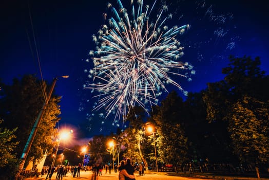 VICHUGA, RUSSIA - JUNE 24, 2017: Festive fireworks and a crowd of people at the Festival of the Day of Vichuga. Russia