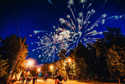 VICHUGA, RUSSIA - JUNE 24, 2017: Festive fireworks and a crowd of people at the Festival of the Day of Vichuga. Russia