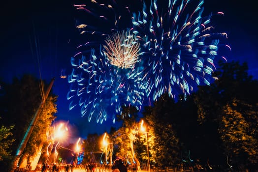 VICHUGA, RUSSIA - JUNE 24, 2017: Festive fireworks and a crowd of people at the Festival of the Day of Vichuga. Russia