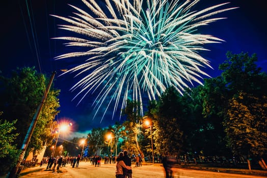 VICHUGA, RUSSIA - JUNE 24, 2017: Festive fireworks and a crowd of people at the Festival of the Day of Vichuga. Russia
