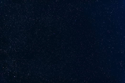 many colorful stars shining in the night dark blue sky with nebulae