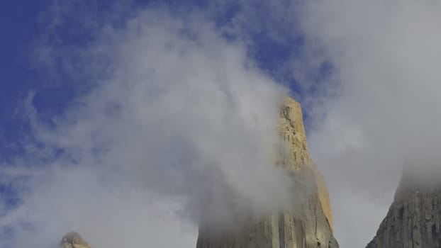 Gorgeous video captures Torres del Paine's peaks shrouded in clouds beneath a clear blue sky.