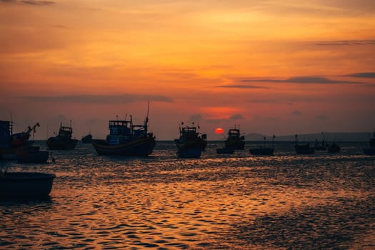 Vietnamese fishing boats in Mui Ne to the sea at sunset