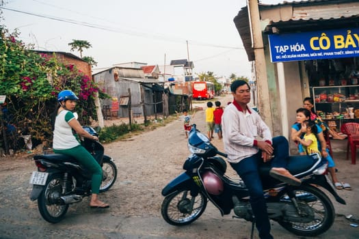 MUI NE, VIETNAM - CIRCA MARCH 2017: People stand on the sidewalk, the life of a Vietnamese