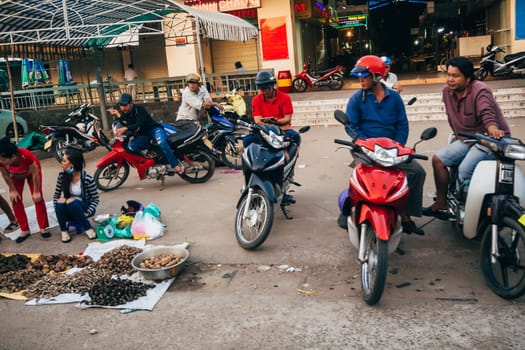 MUI NE, VIETNAM - CIRCA MARCH 2017: A woman sells sea shellfish on the street on the sidewalk