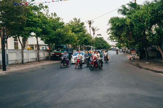 MUI NE, VIETNAM - CIRCA MARCH 2017: Crowded traffic on the road on motorbikes and cars in Vietnam